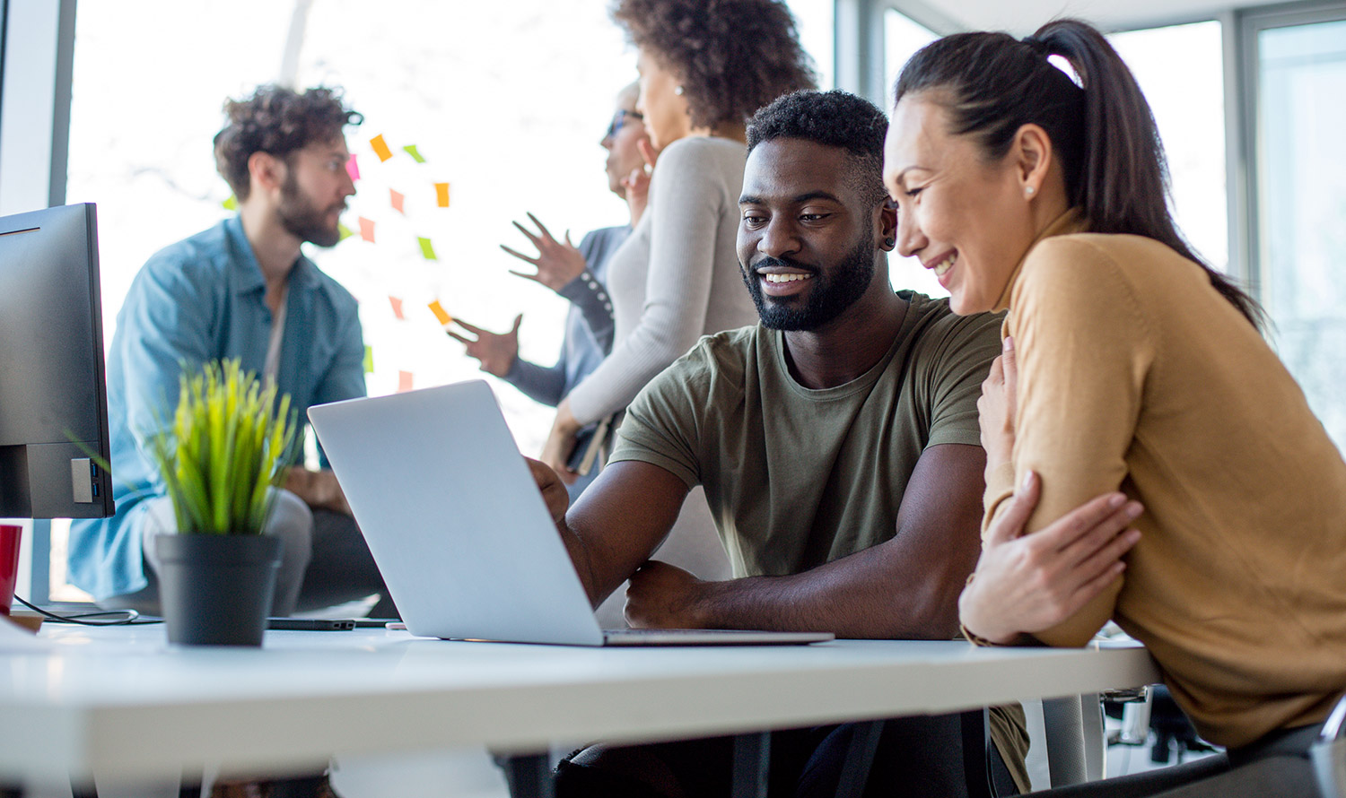 Collaborative Employees Looking at a Laptop